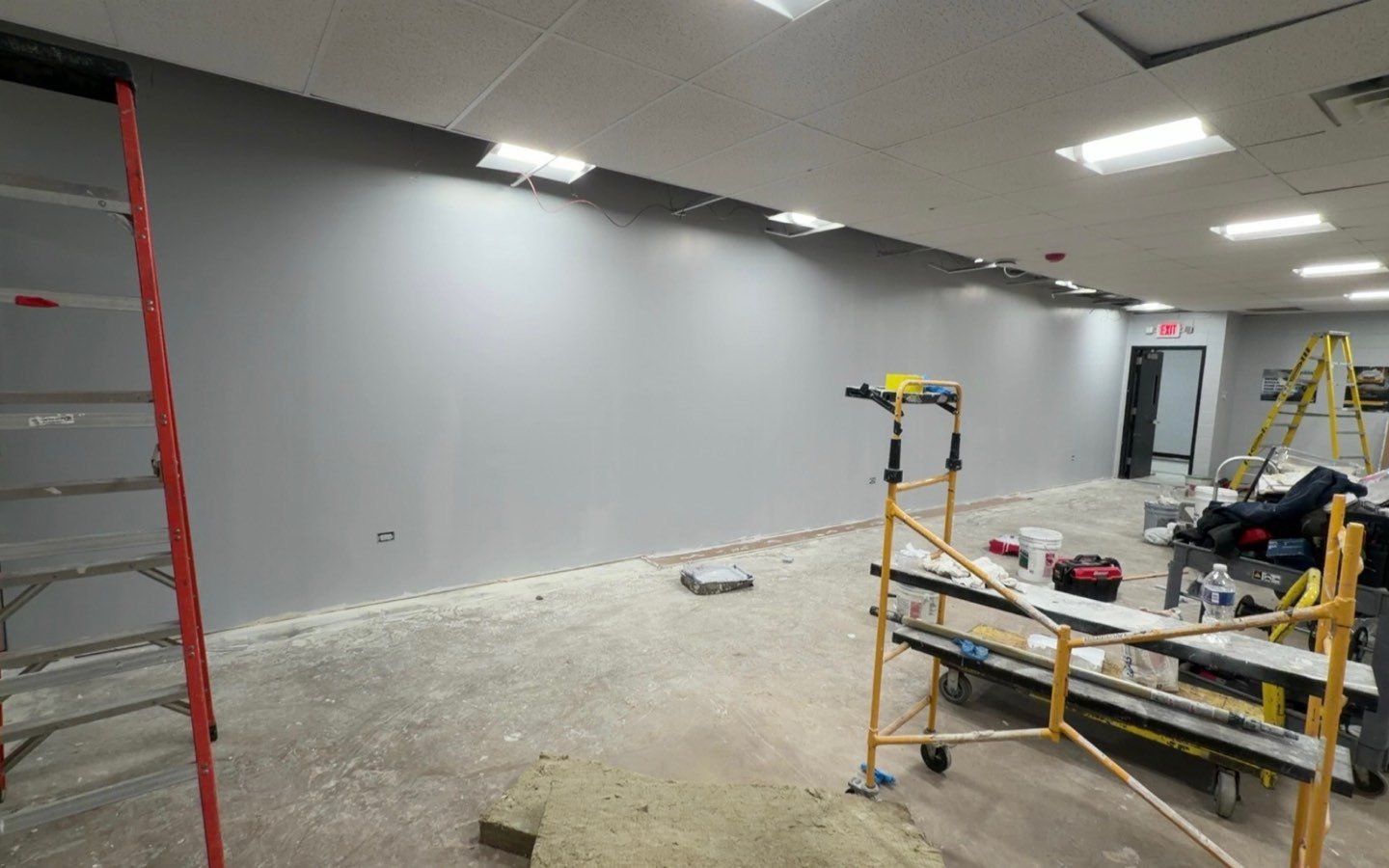 The same commercial room finished, drywalled, painted and lit