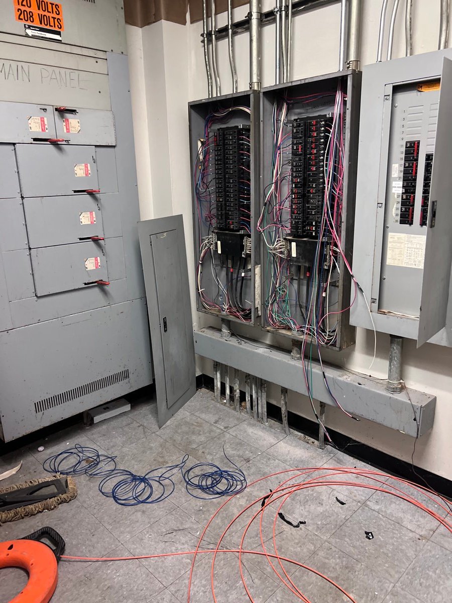 Bank of commercial electrical panels with conduit runs