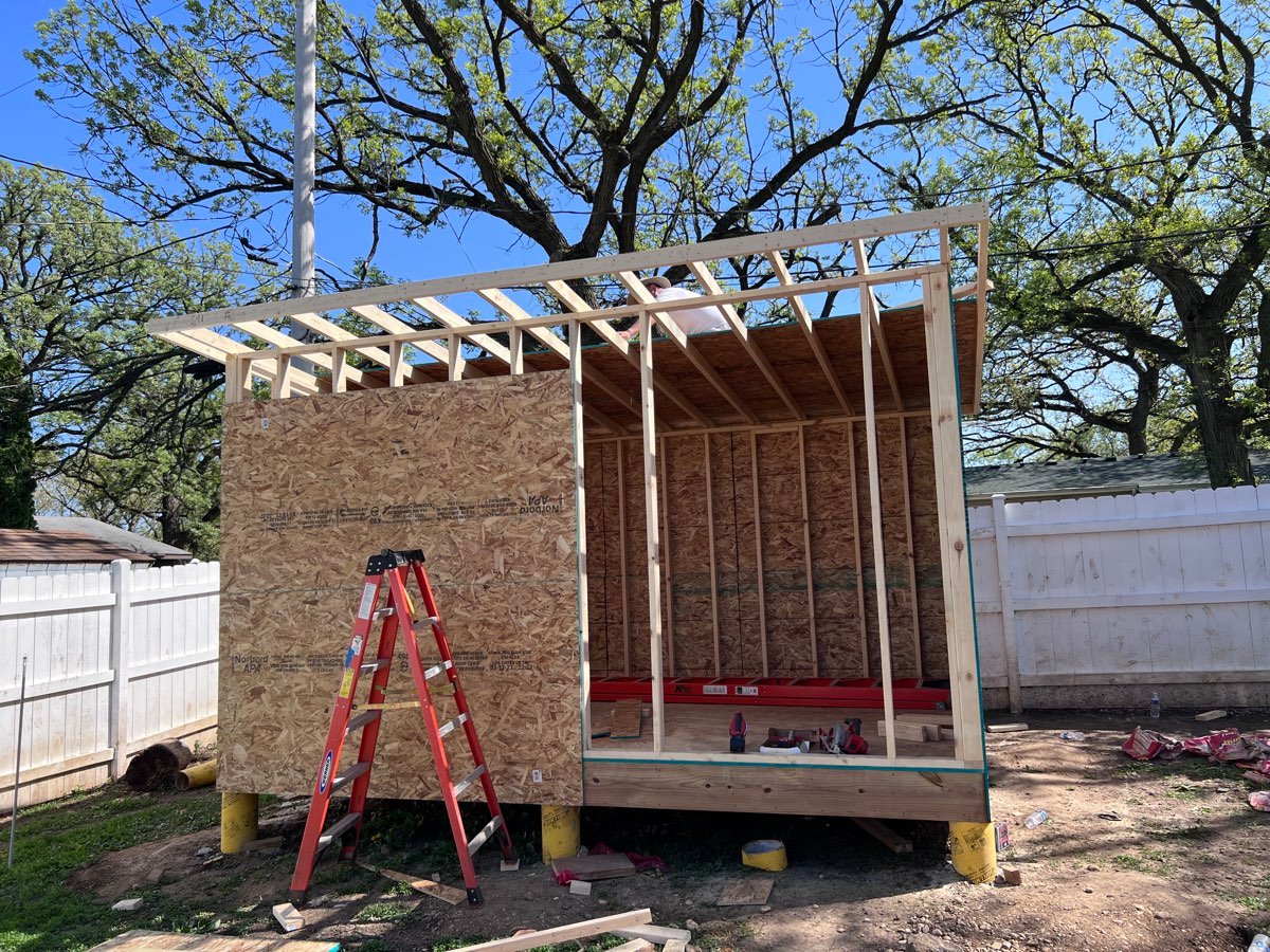Detached structure framed and sheathed in a residential yard