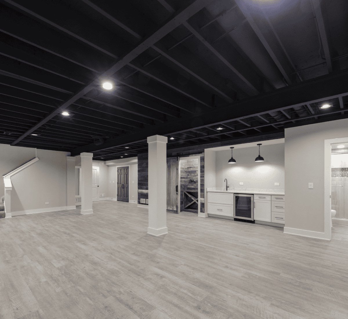Finished office build out with exposed black ceiling and recessed lighting